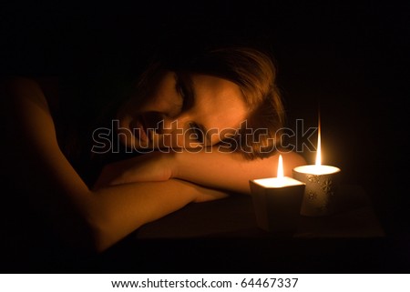 Portrait of the romantic girl by the light of candles