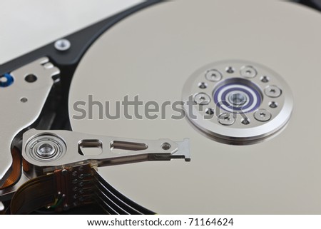 A close up of an opened computer hard disk