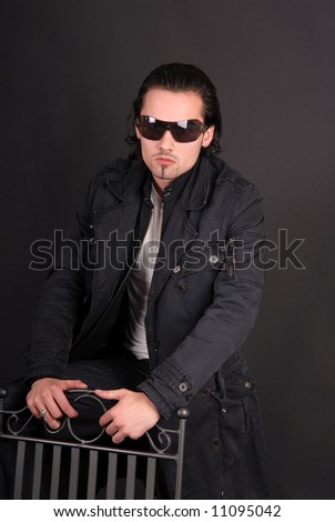 fashion guy in sunglasses with chair