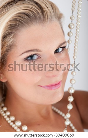 Young beautiful glamour woman with healthy skin and white pearl necklace