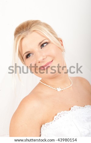 Portrait of Young happy pretty bride with perfect bridal make-up. studio shot