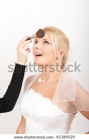 Bridal make up on young pretty bride in white wedding dress