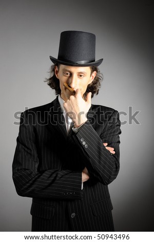 picture of young intelligent gangster man with cigare on gray background