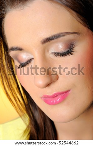 portrait of pretty relaxed woman with natural make-up. yellow background
