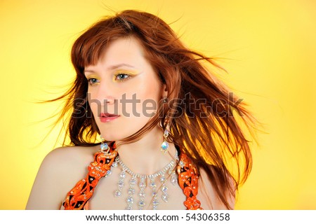 Beautiful mystic woman with golden make-up . yellow background