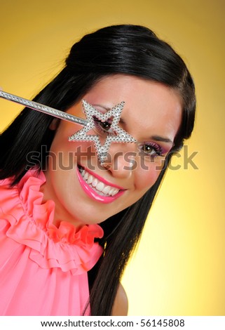 Beautiful woman with creative make-up and the star making a wish. focus on star