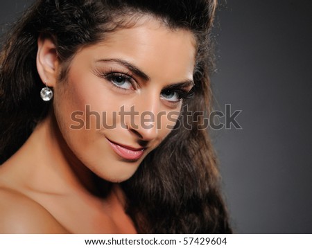 Beautiful brunette woman with natural make-up and healthy skin. black background