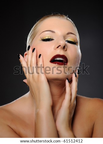 Emotional pretty woman face with bright make-up and violet lipstick screaming