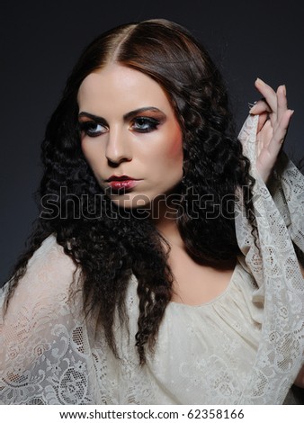 Gothic female portrait with creative make-up and white pure skin