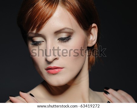 Portrait of pretty woman with pure healthy skin and natural make-up in brown tones looking down