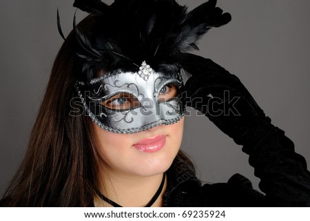 Beautiful sexy woman in party carnival mask . isolated on gray background