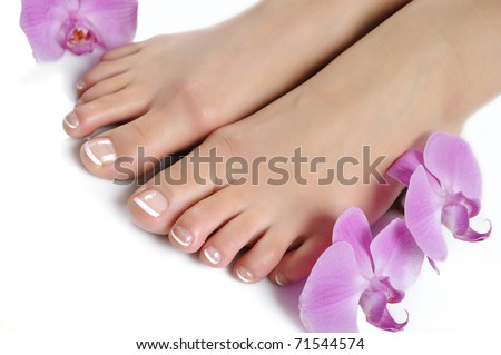 stock photo Beautiful feet with perfect spa french nail pedicureisolated