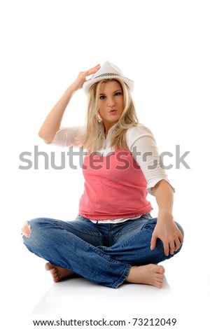 young casual smiling woman in white hat sitting on the floor having fun  isolated