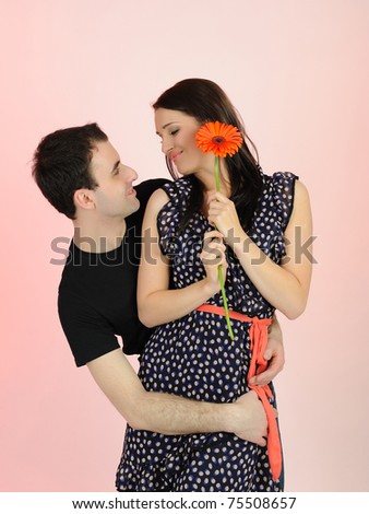 lovely romantic man giving flower to a woman