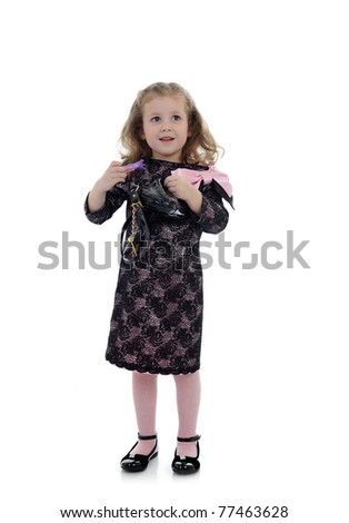 Pretty little child girl in black elegant party dress with lipstick. isolated