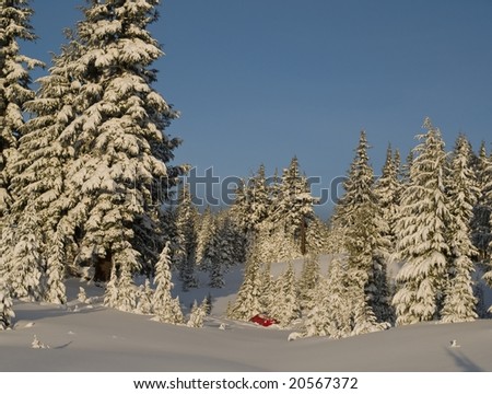 A winter tent camp out is nestled amongst the snow covered trees in the Three Sisters Wilderness of central Oregon State