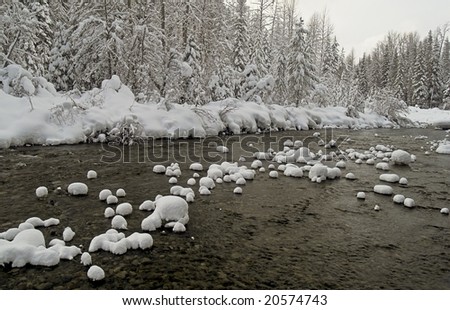 Pillows of snow cover the rocks and boulders of the Similkameen River in Southern BC, Canada