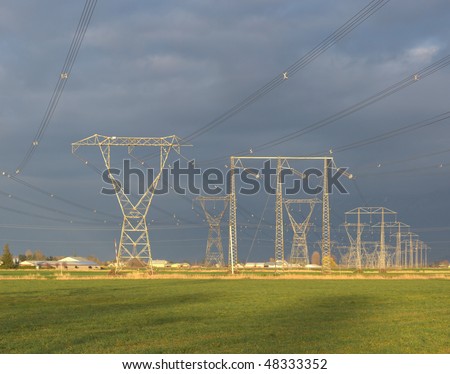 Rows of power lines cross over a rural area