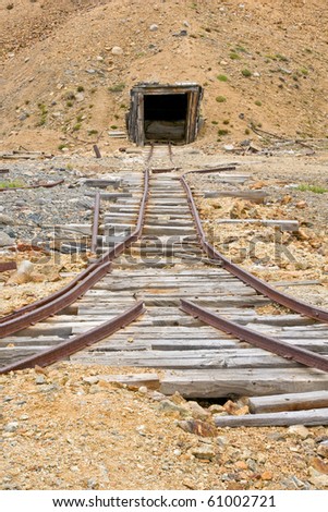 Old rail tracks leading to  an abandoned mine shaft in Yukon Territory