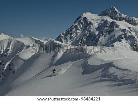 A back country skier begins his decent with Mt. Shuksan in background