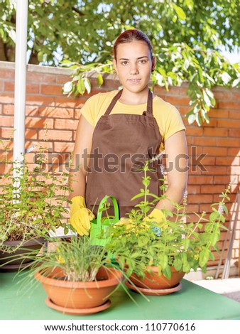 A young woman in a garden jobs on a sunny day