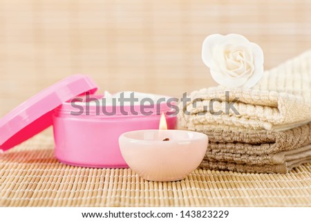 Skin care set with romantic candle in front