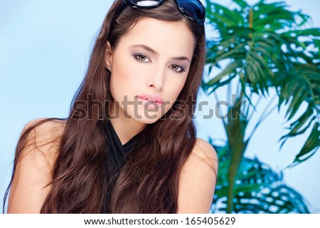 Pretty woman with summer glasses in her long hair