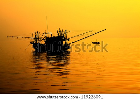 Fishing boat sunrise ,Silhouette of a fishing boat.