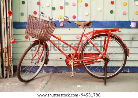 Red bicycle and colorful wood wall