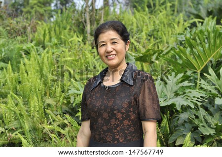 asian middle-aged woman in nature
