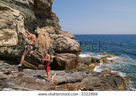 Two girls climbing on the cliff