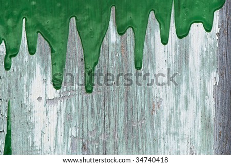 Green paint pouring on vintage wall background