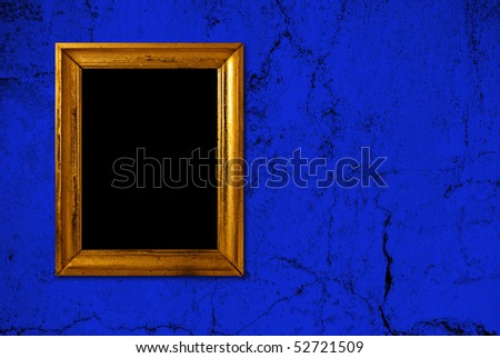 Gold frame on a old blue wall