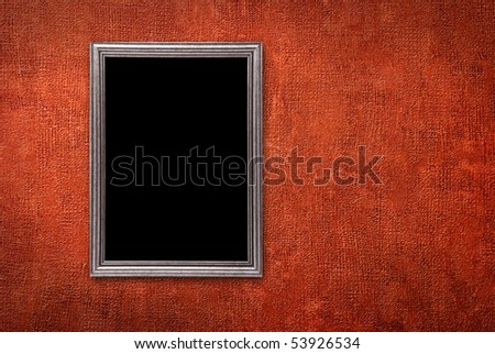 Silver frame on a red wall background