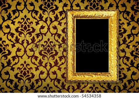 Gold frame on a vintage yellow wall background