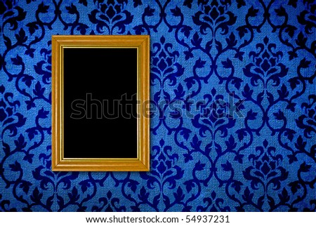 Gold frame on a vintage blue wall background