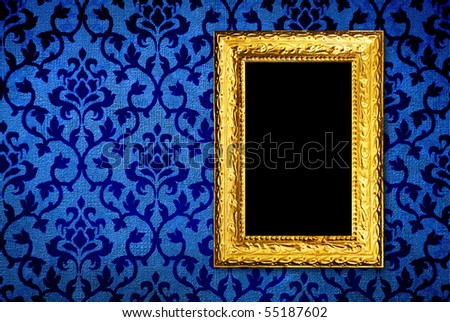Gold frame on a vintage blue wall background