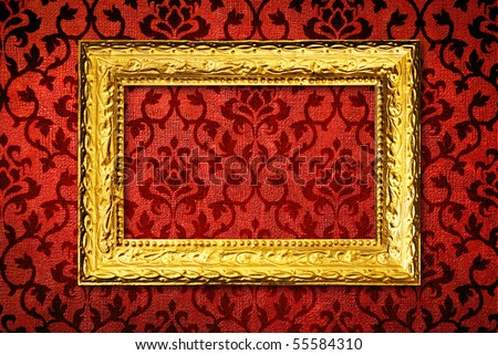 Gold frame on a vintage red wall background
