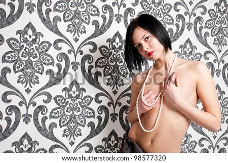 Fashion portrait nude elegant woman on vintage wallpaper background