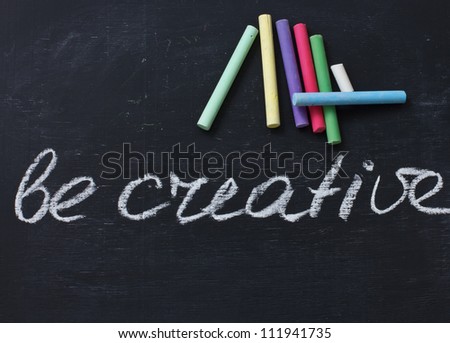 Words be creative written by white chalk on blackboard