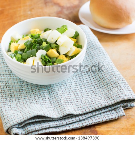 Delicious egg salad in bowl on table. Selective focus. Square image.