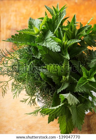 Fresh organic herbs  - mint, lemon balm, fennel on wooden background. Selective focus.