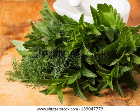Fresh organic herbs  - mint, lemon balm, fennel, parsley on wooden background. Selective focus.