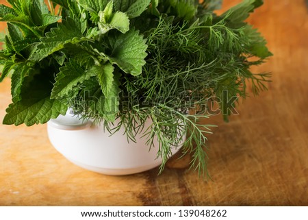 Fresh organic herbs  - mint, lemon balm, fennel on wooden background. Selective focus.