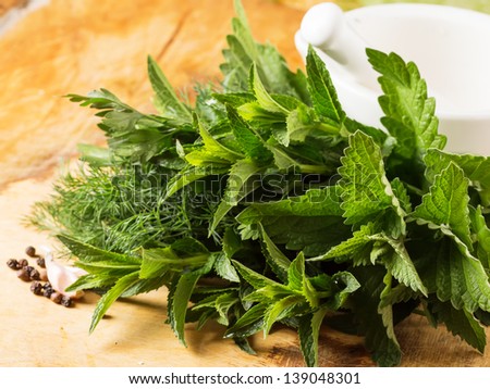 Fresh herbs - mint, fennel, parsley on wooden background. Selective focus.