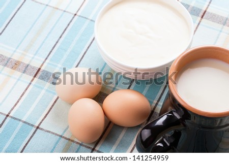 Fresh dairy products - milk, sour cream, eggs. Rustic style. Bio/organic/natural ingredients. Healthy eating.