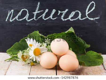 Fresh organic eggs. Selective focus. Natural/bio/organic/eco products. Word natural on blackboard.