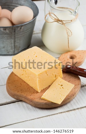 Fresh dairy products - cheese, milk, eggs. Rustic style. Bio/organic/natural ingredients. Healthy eating.