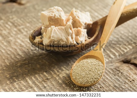 Dry and fresh yeast on old wooden background. Rustic style. Selective focus. Natural/organic/bio/eco products.