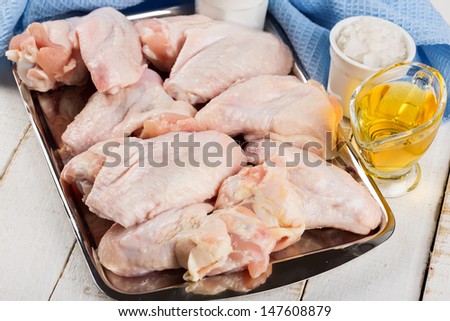Fresh chicken meat on wooden table. Selective focus. Rustic style.